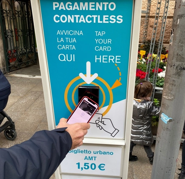 A picture of a person using their mobile phone to pay